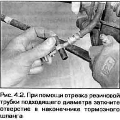 2. Loosen the hose mounting bolt and disconnect the hose from the caliper (see Figure 3.6,b). Plug…