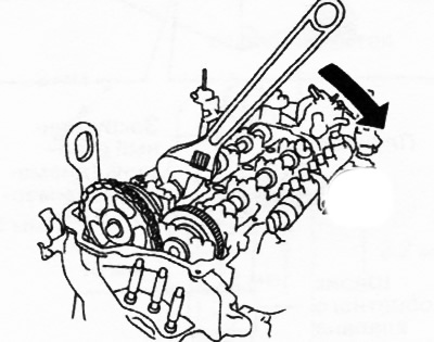While moving the exhaust camshaft in the direction of the arrow in the figure, using a wrench…