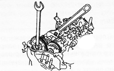 18. Holding the exhaust camshaft by the hexagonal part with an adjustable wrench, loosen the…